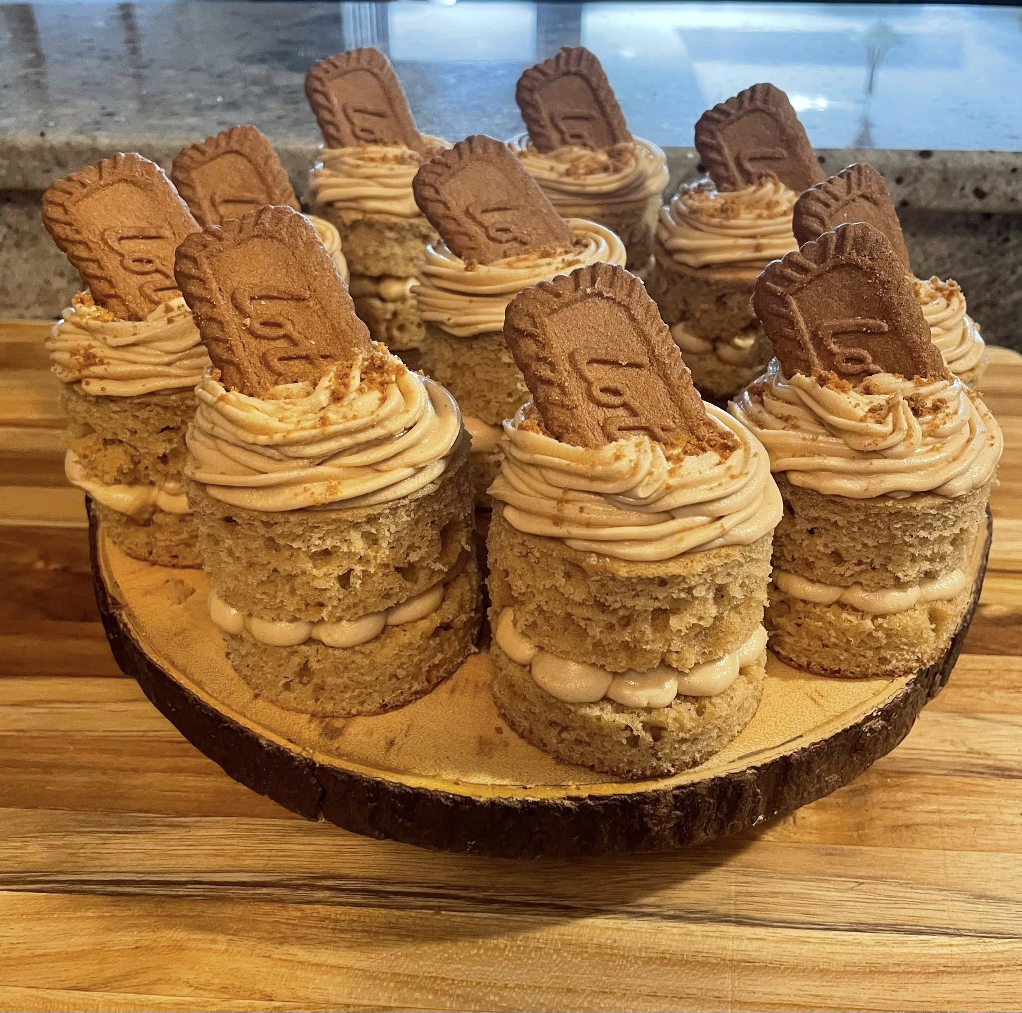 Platter of finished Biscoff mini cakes on rustic wood stand