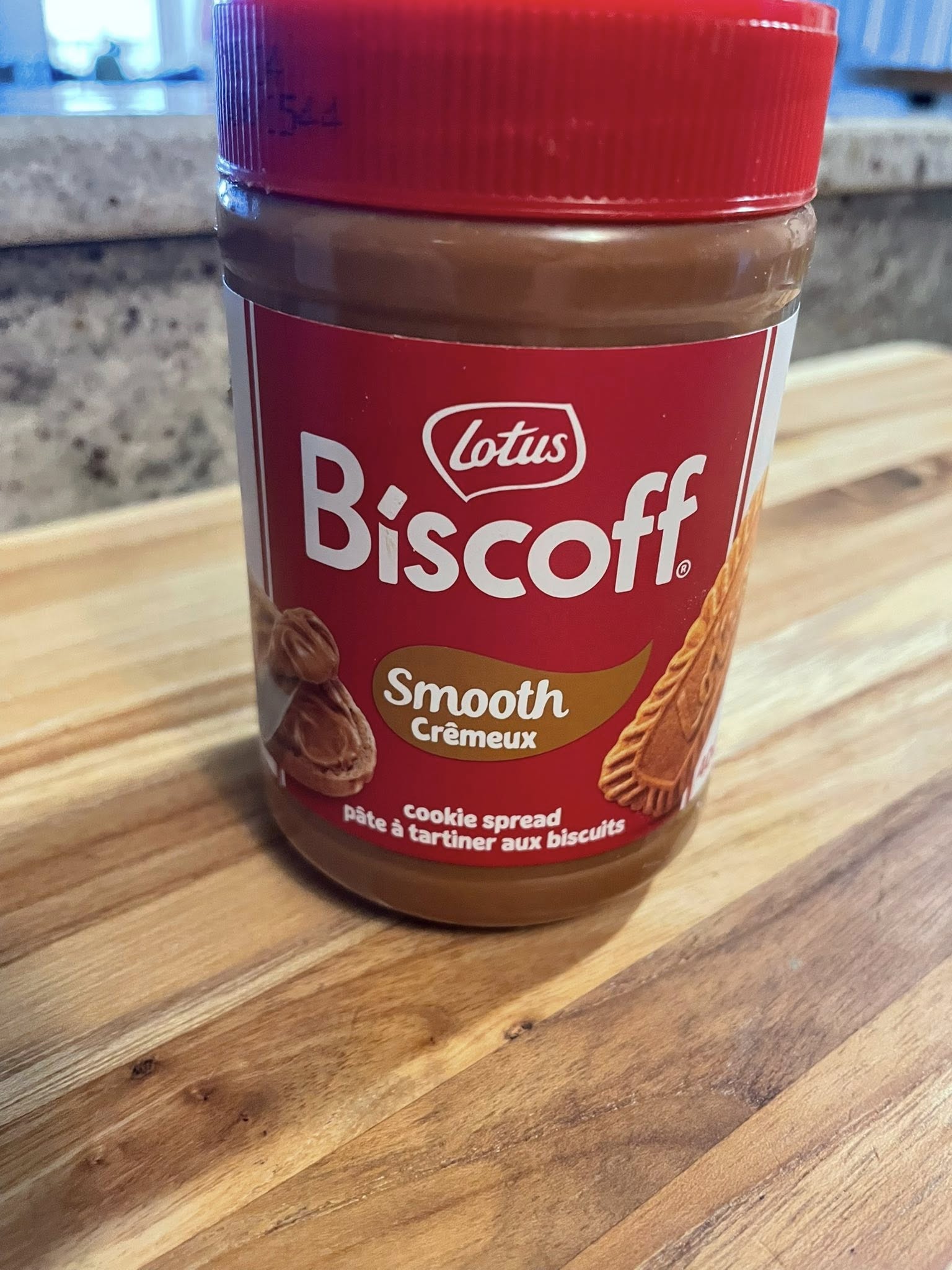 Jar of Lotus Biscoff cookie butter on butcher‑block counter