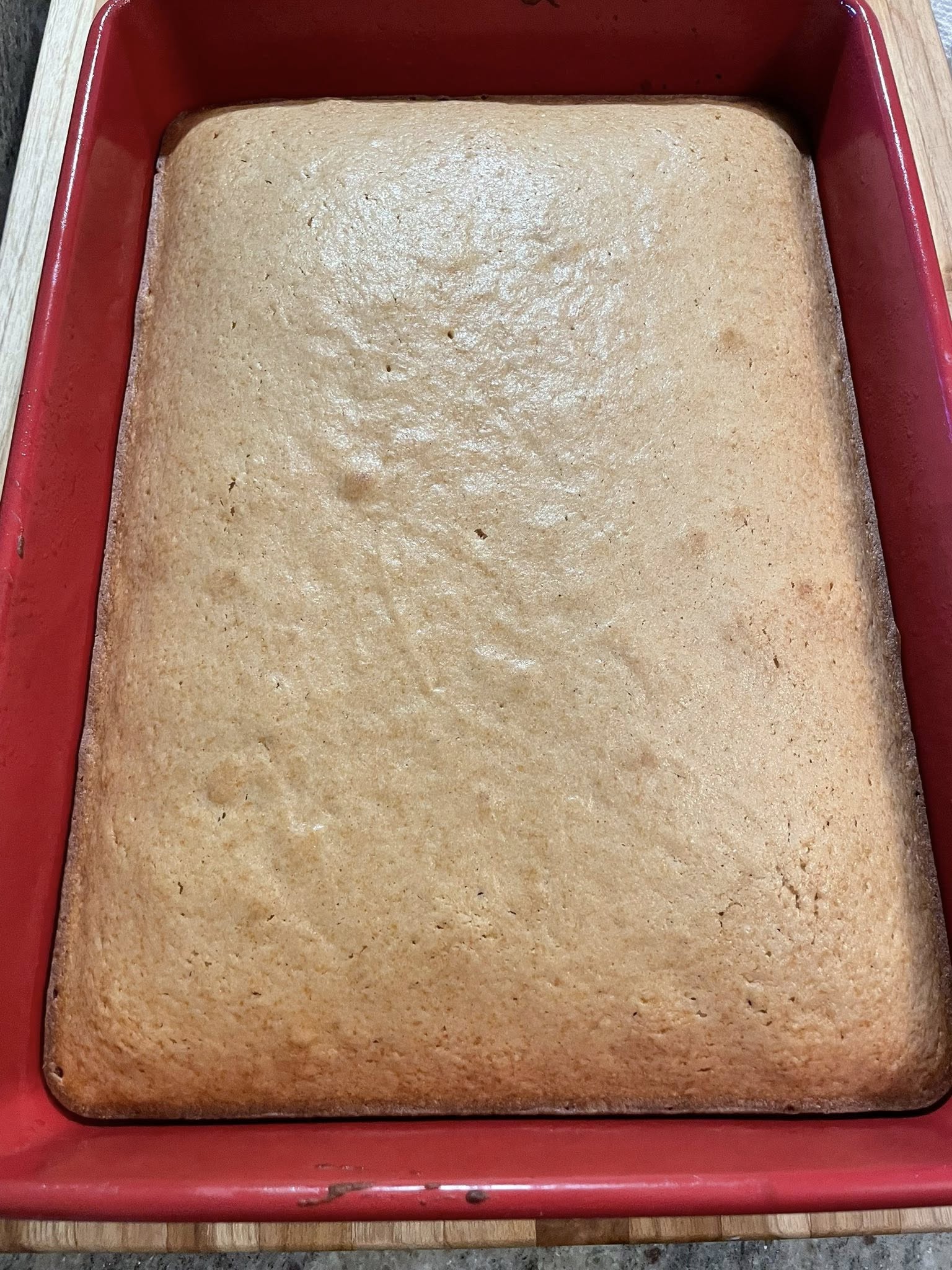 Freshly baked Biscoff mini cakes sheet cooling in red pan