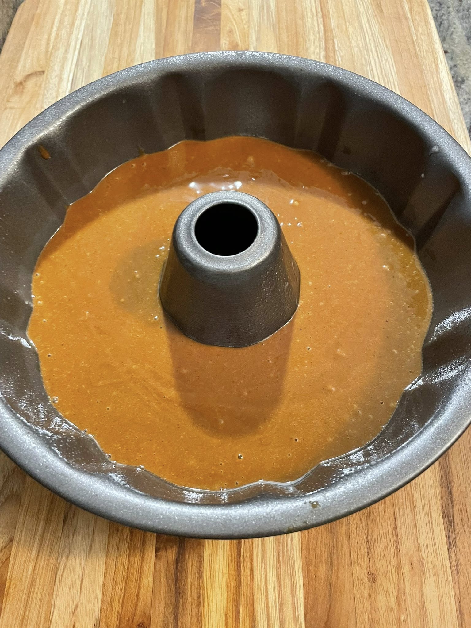 One‑bowl gingerbread bundt cake batter in a dark pan, ready to bake