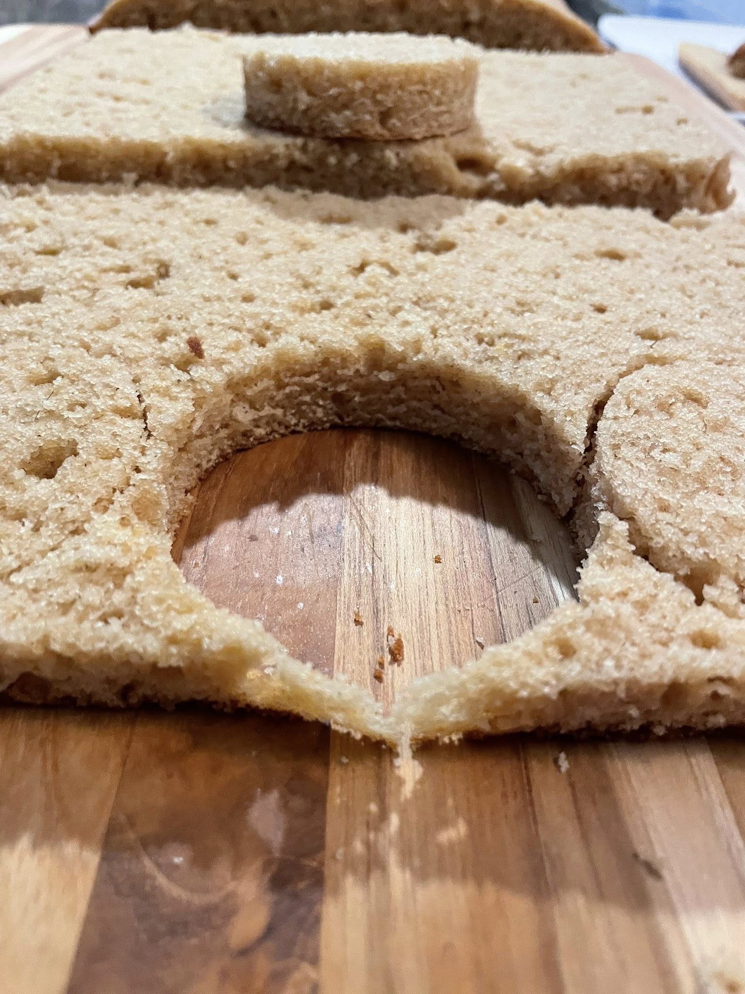 Cutter punching individual Biscoff cakes from sheet.