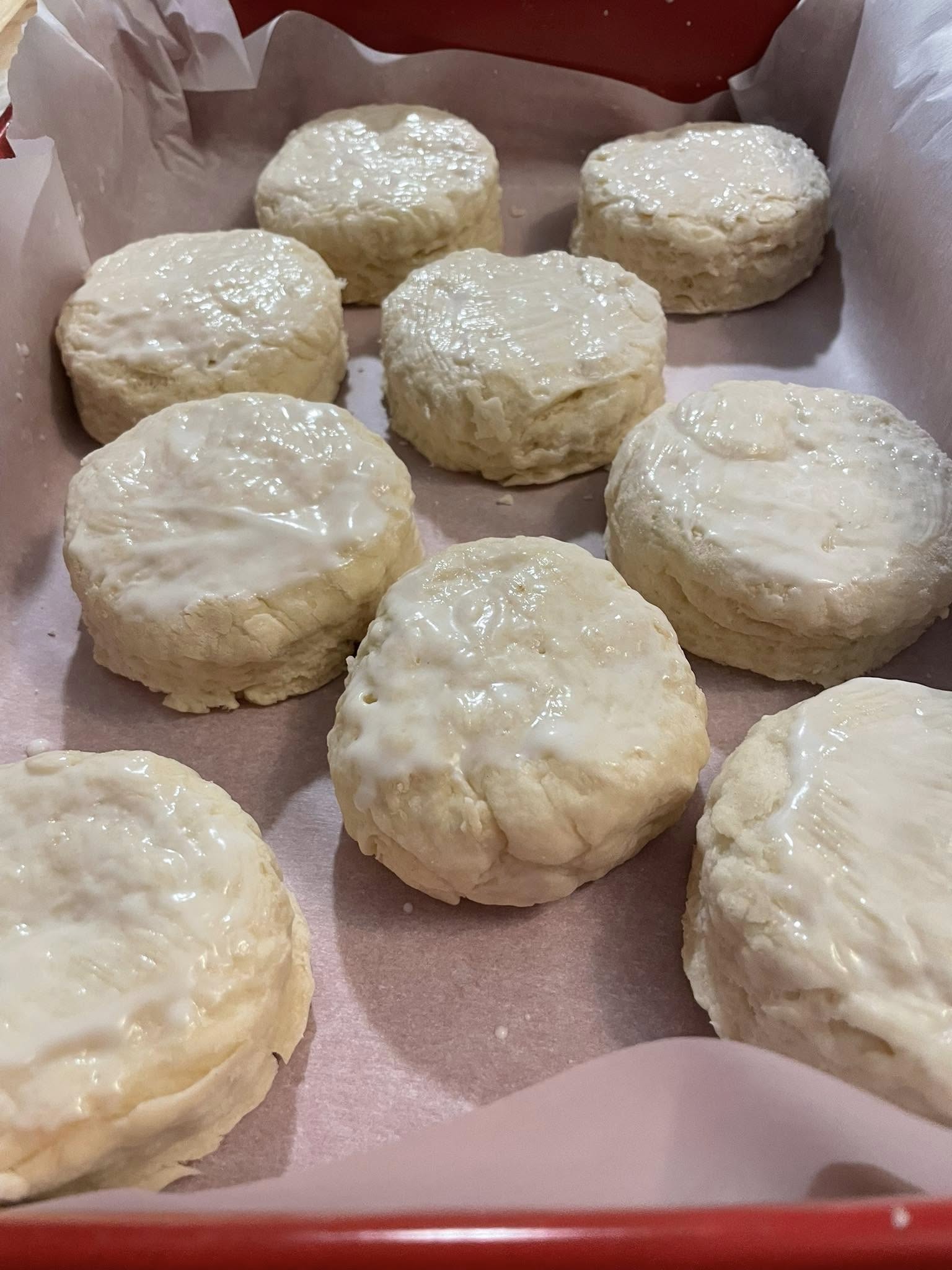 a tray of biscuits with white glaze