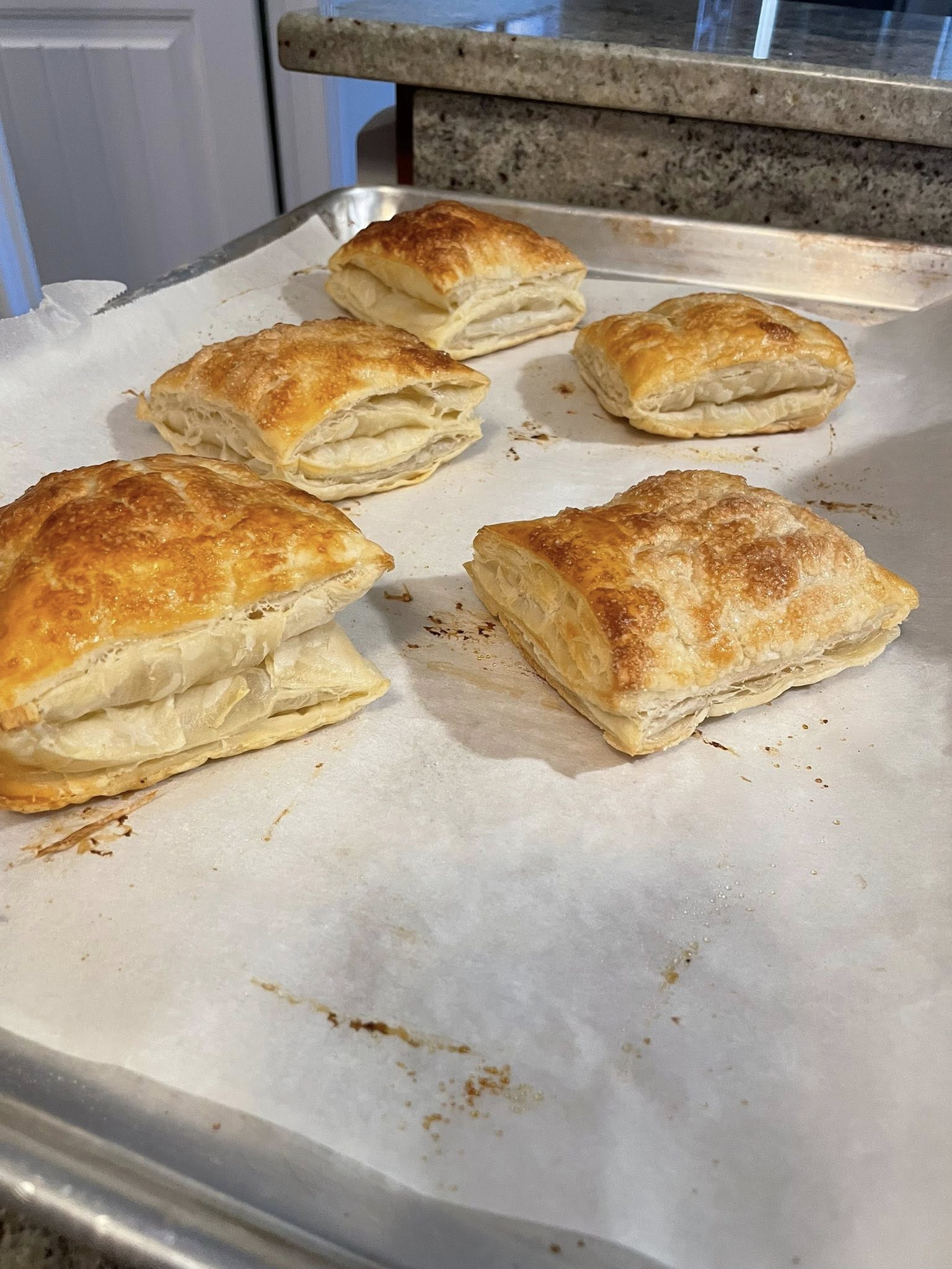 Extra baked puff pastry flakies on parchment paper for serving with pot pie